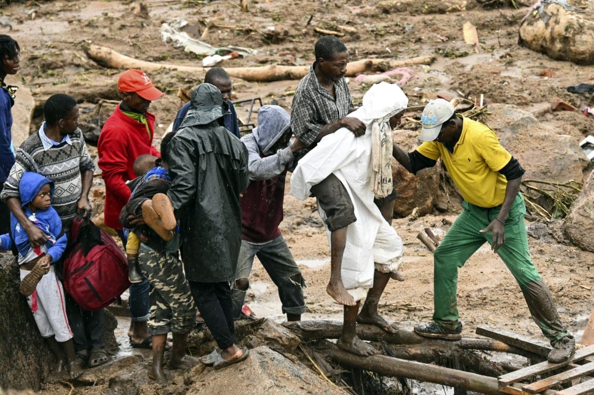 An injured man helped across in Blantyre, Malawi