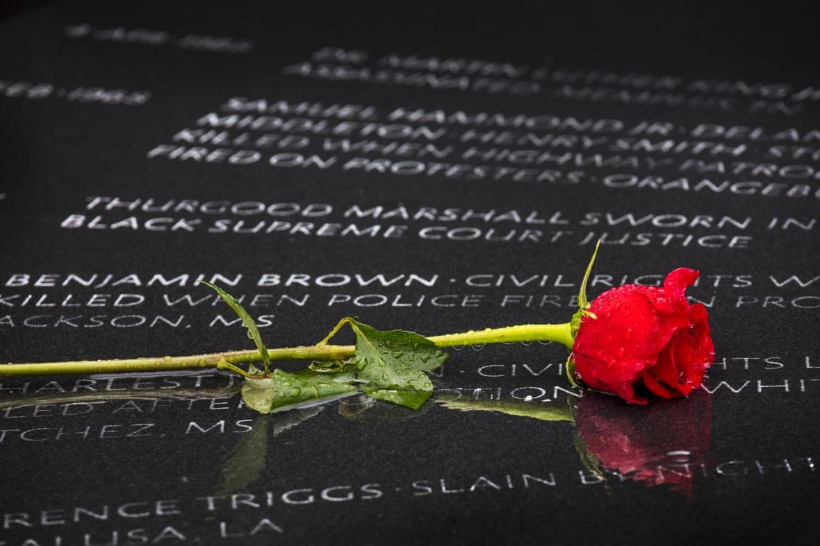 A rose lays on the Civil Rights Memorial