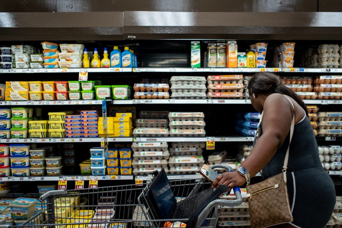 A customer shops for eggs in a Kroger grocery store