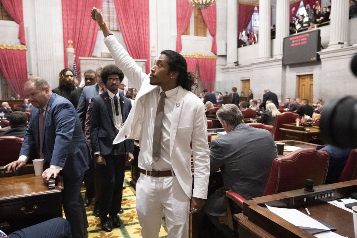Democratic Representative Justin Jones of Nashville raises his fist on the floor of the House