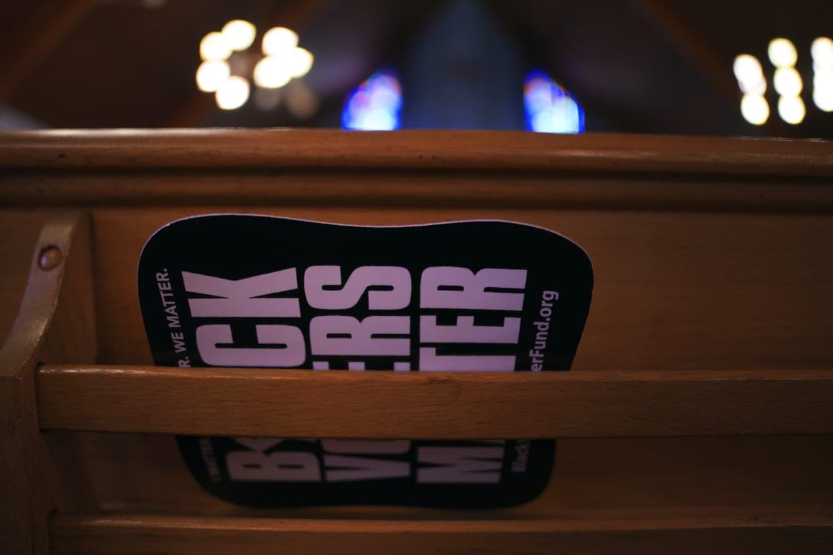 A fan reading "Black Voters Matter" in the back of a pew at Bethel AME Church 