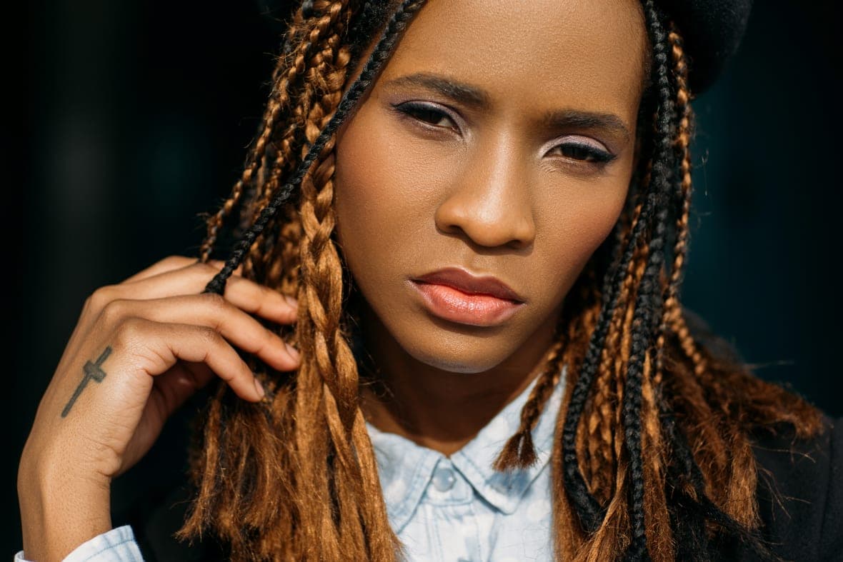 A woman with long hair in several varied braids