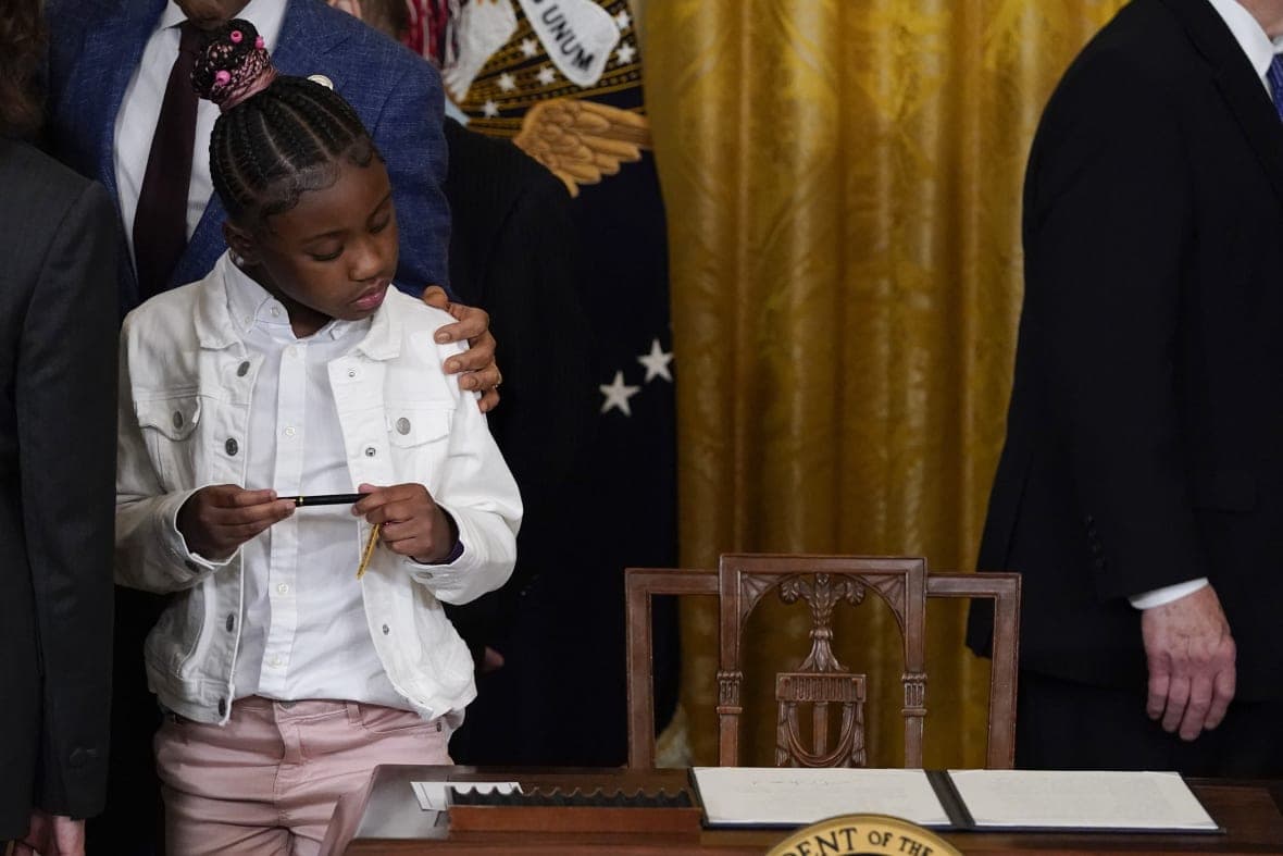 Gianna Floyd, daughter of George Floyd, looks at the executive order on policing that President Joe Biden signed