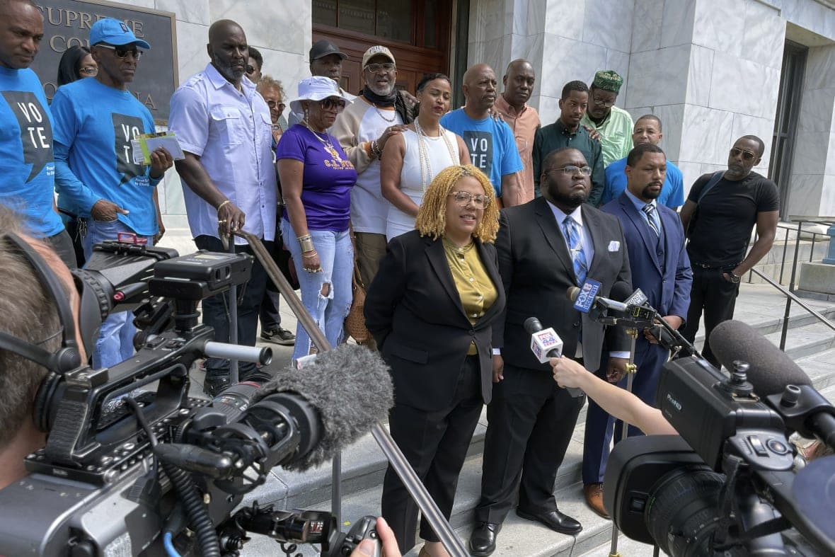 Attorneys and criminal justice advocates stand outside Louisiana’s Supreme Court