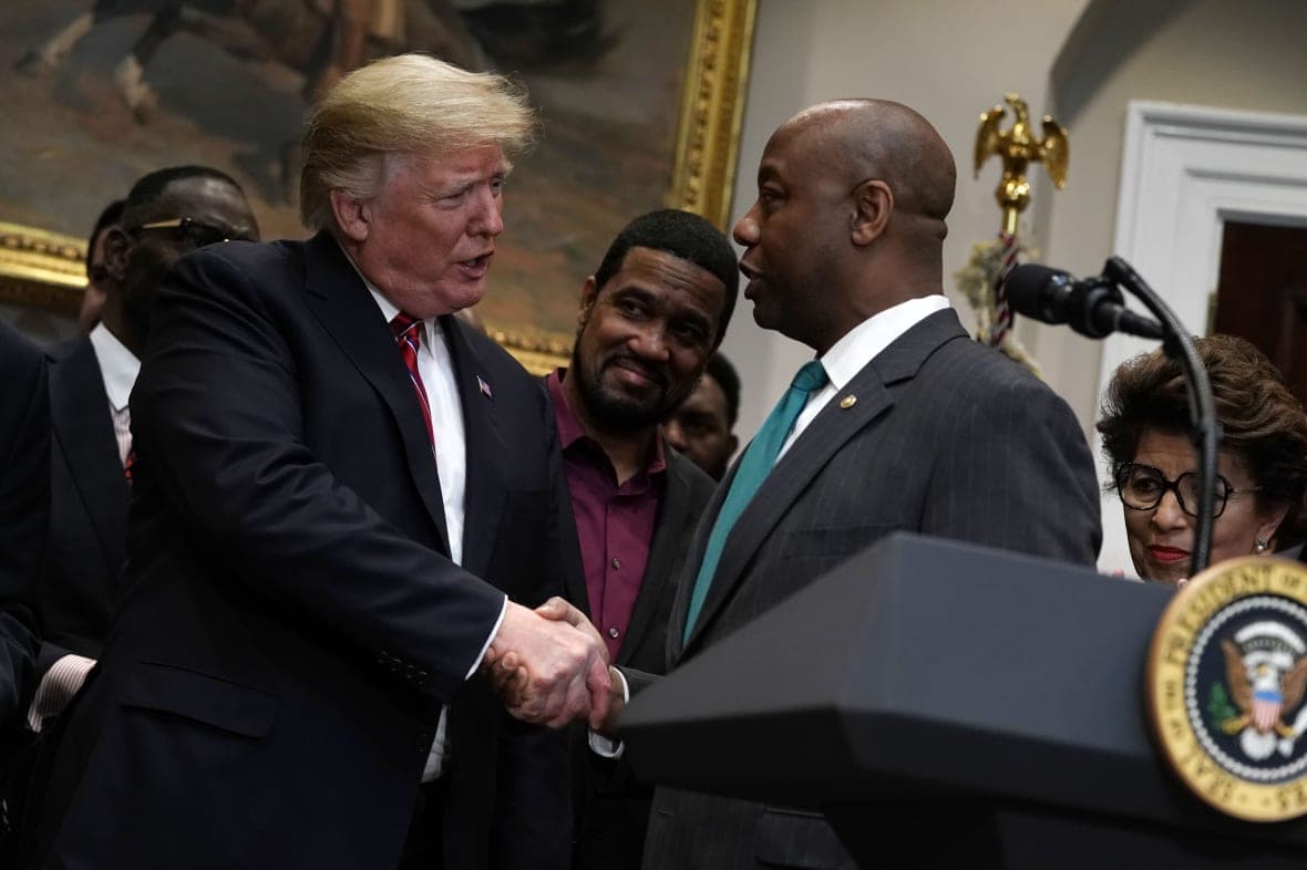 Former President Donald Trump shakes hands with Republican Senator Tim Scott of South Carolina