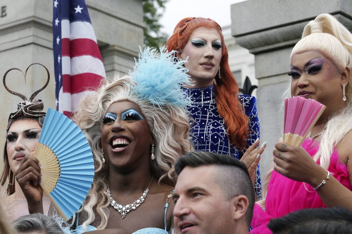 Drag performer Kori King holds a fan