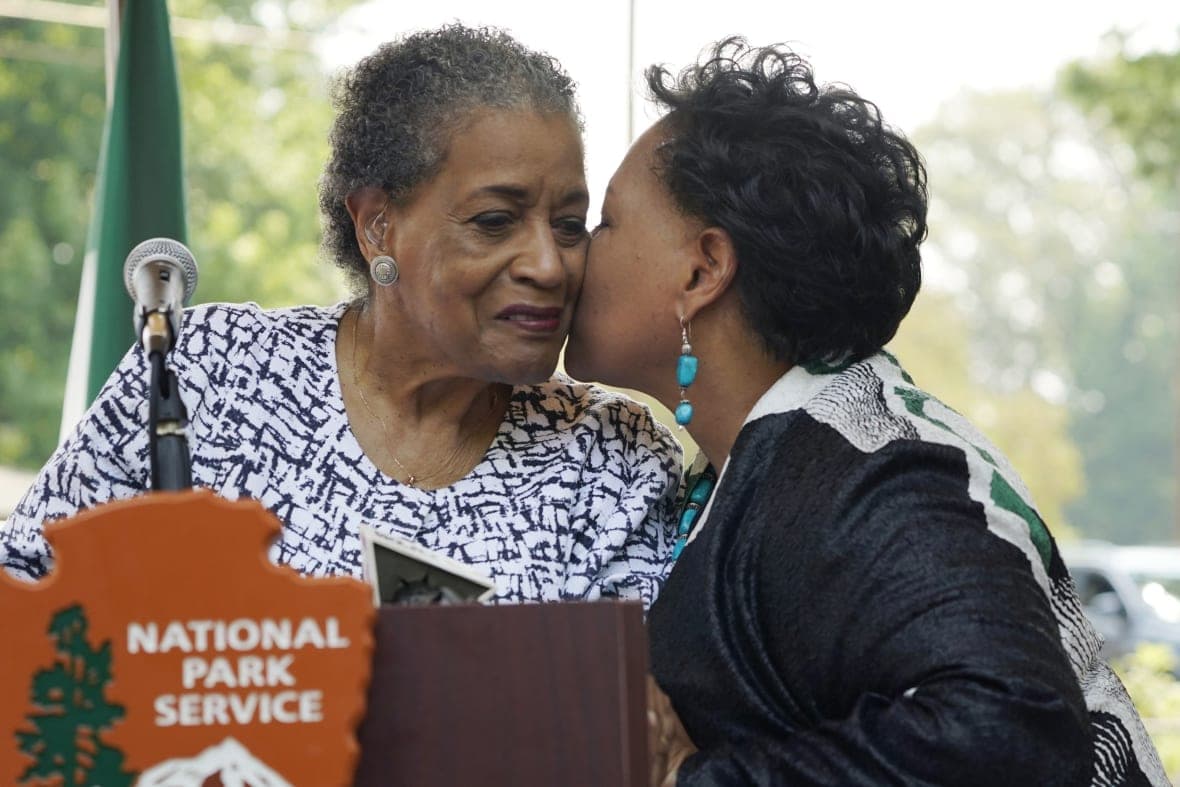 Myrlie Evers is kissed by her daughter Reena Evers-Everette