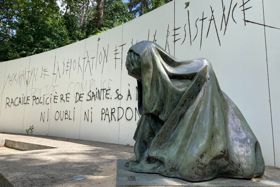 Anti-police graffiti on a monument commemorating Holocaust victims