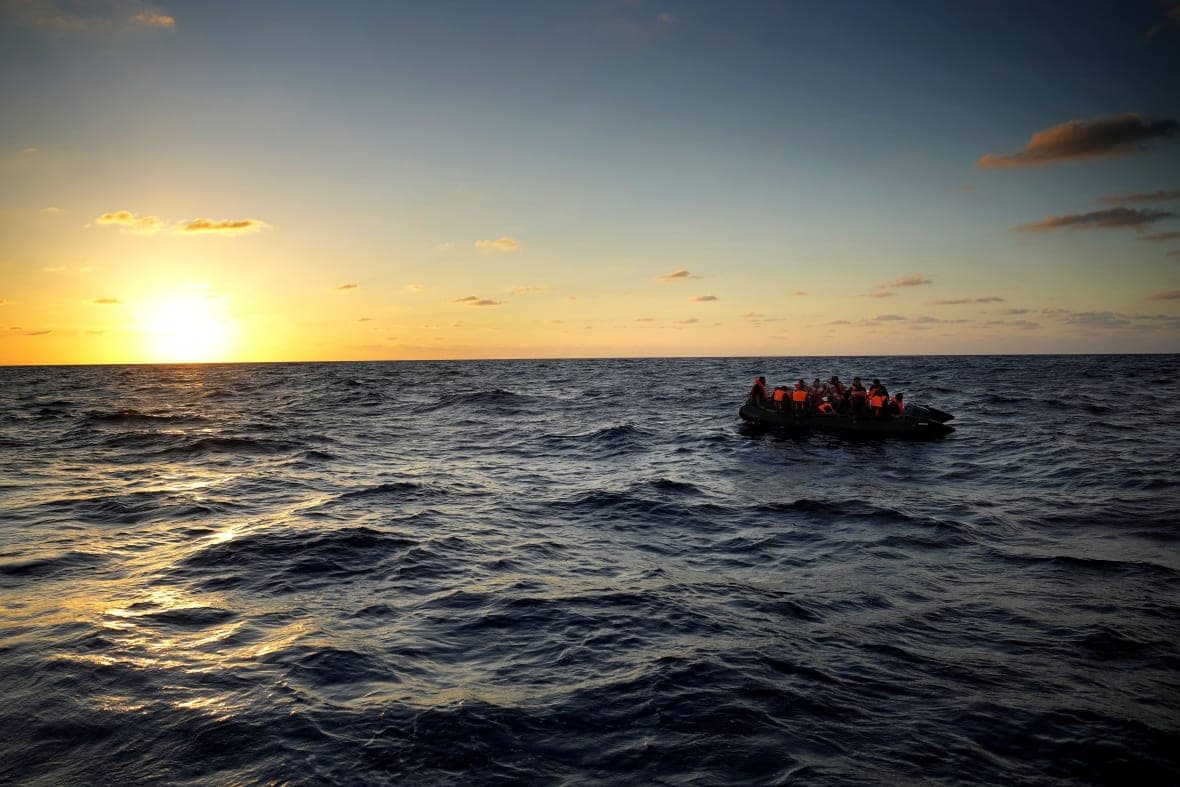 Migrants wait to be rescued by the Spanish NGO Open Arms lifeguards