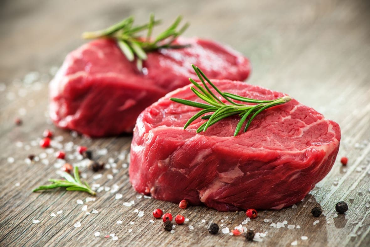 Two beef filets with sprigs of rosemary and salt