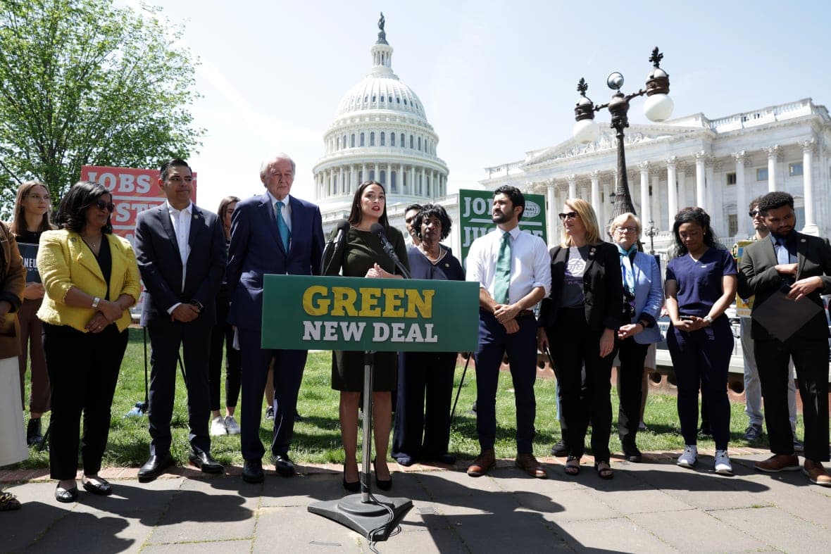 Rep. Alexandria Ocasio-Cortez (center) with Sen. Ed Markey next to her as they reintroduce the Green New Deal Resolution