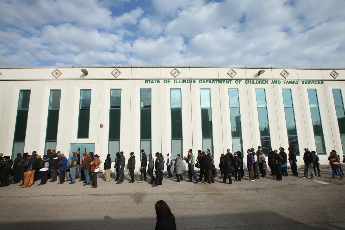 Job seekers wait in line at Kennedy-King College to attend a job fair