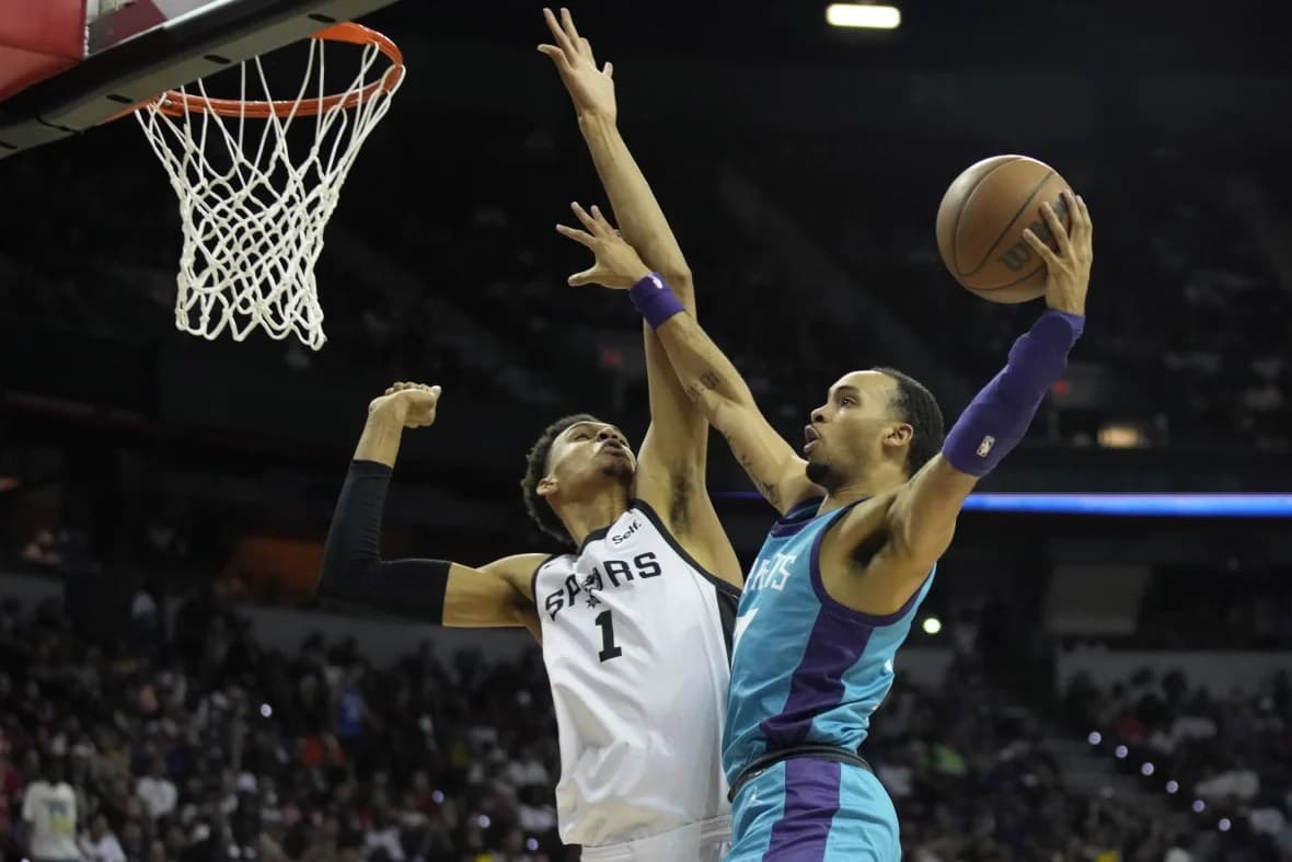 San Antonio Spurs’ Victor Wembanyama, left, fouls Charlotte Hornets’ Amari Bailey