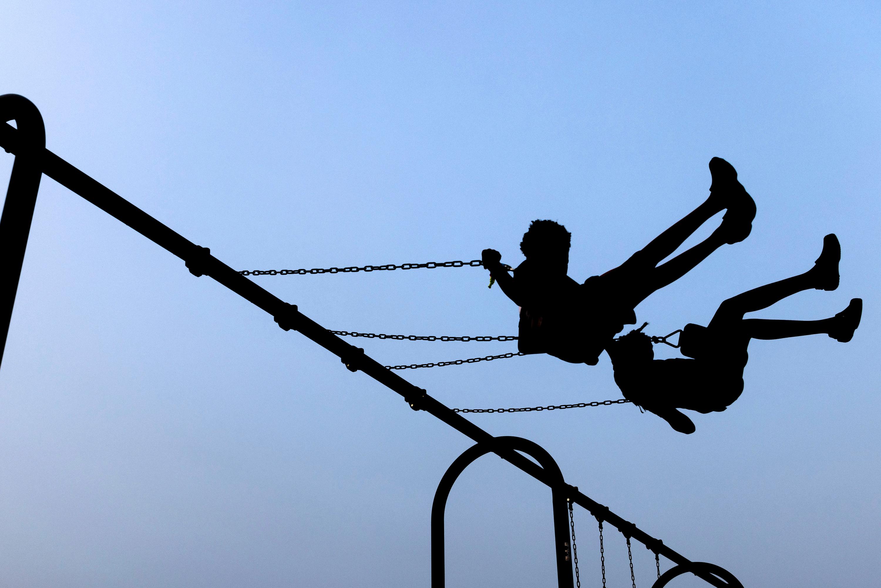 Children play on swings