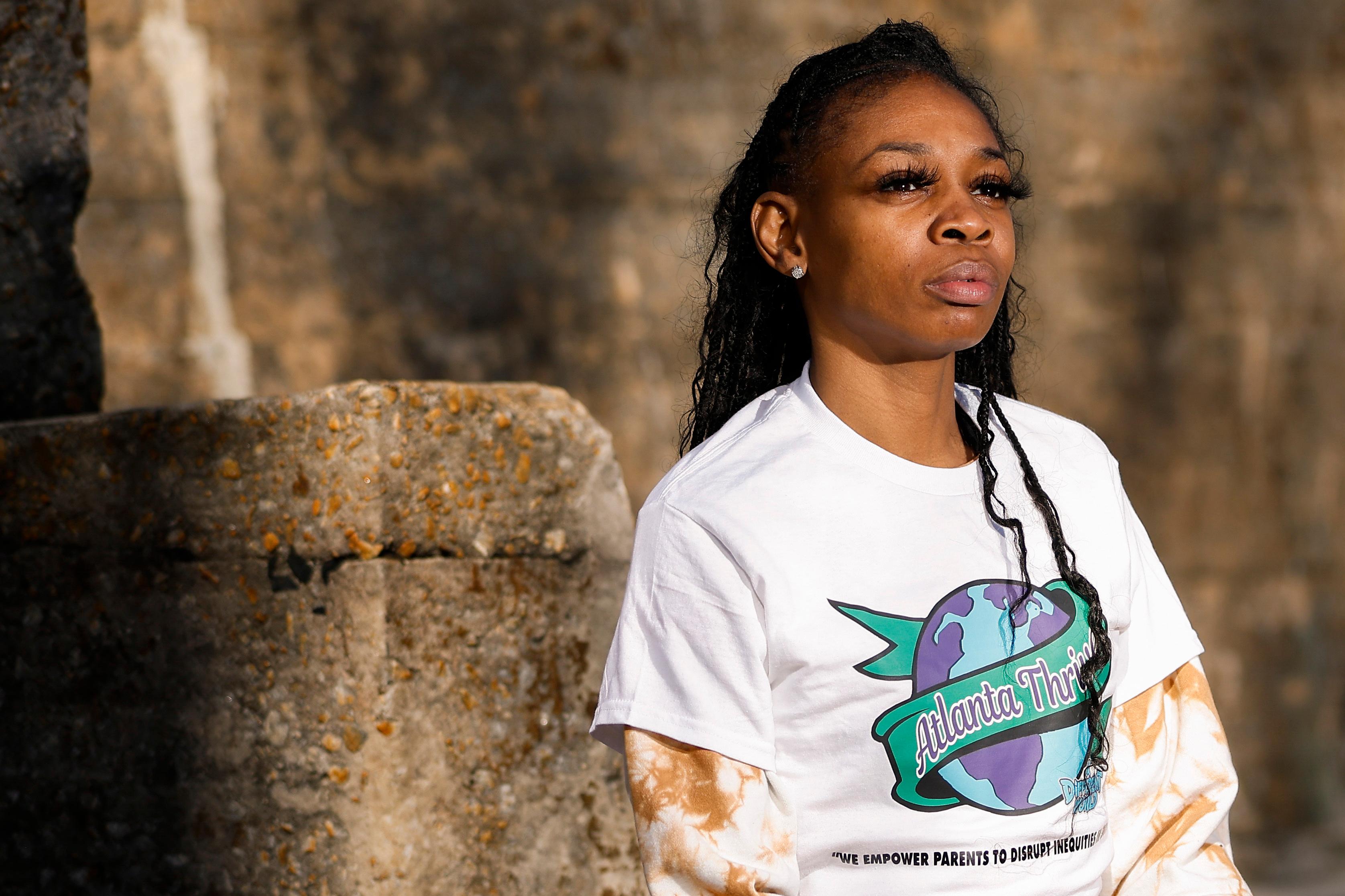 Kimberly Dukes wearing a white "Atlanta Thrives" T-shirt