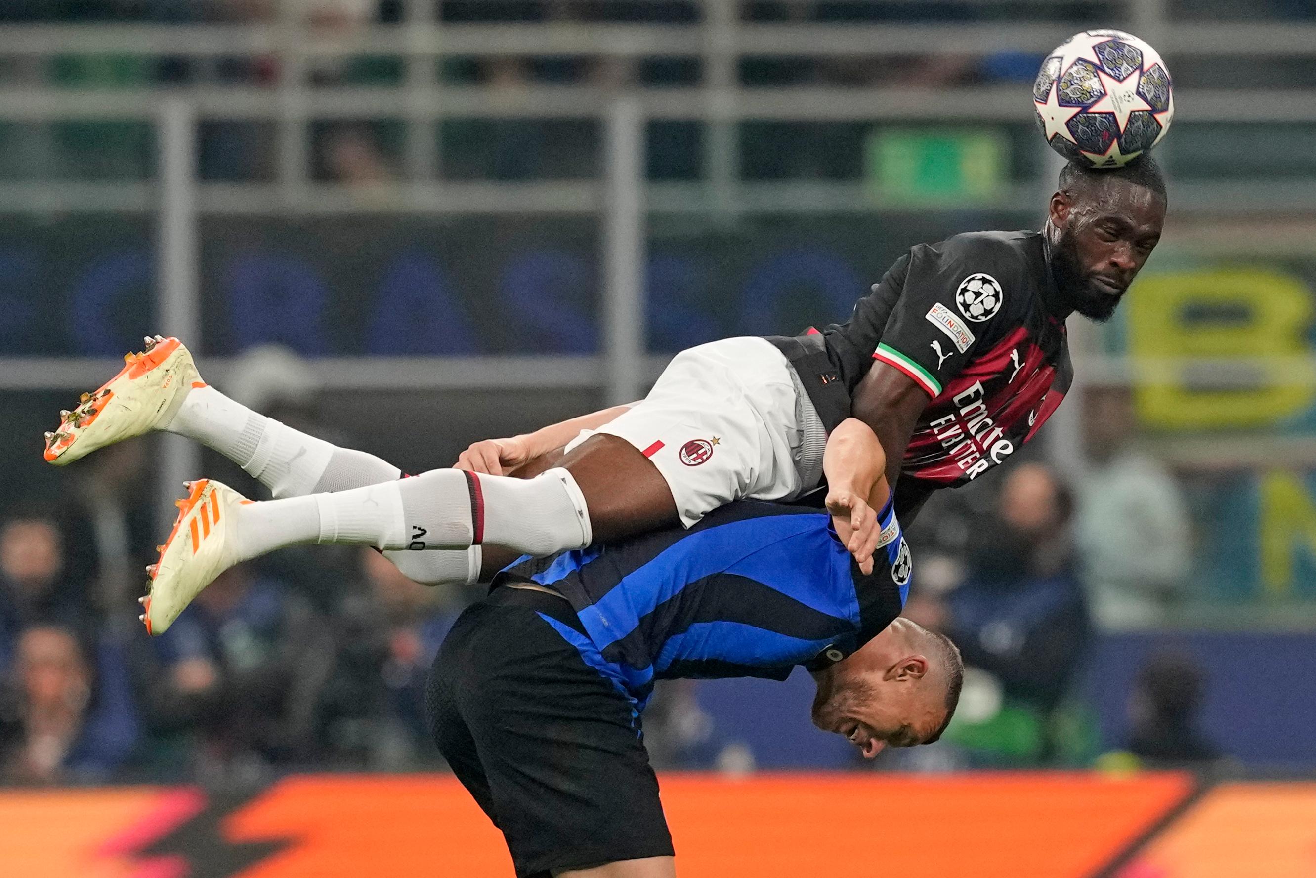 AC Milan’s Fikayo Tomori above Inter Milan’s Edin Dzeko
