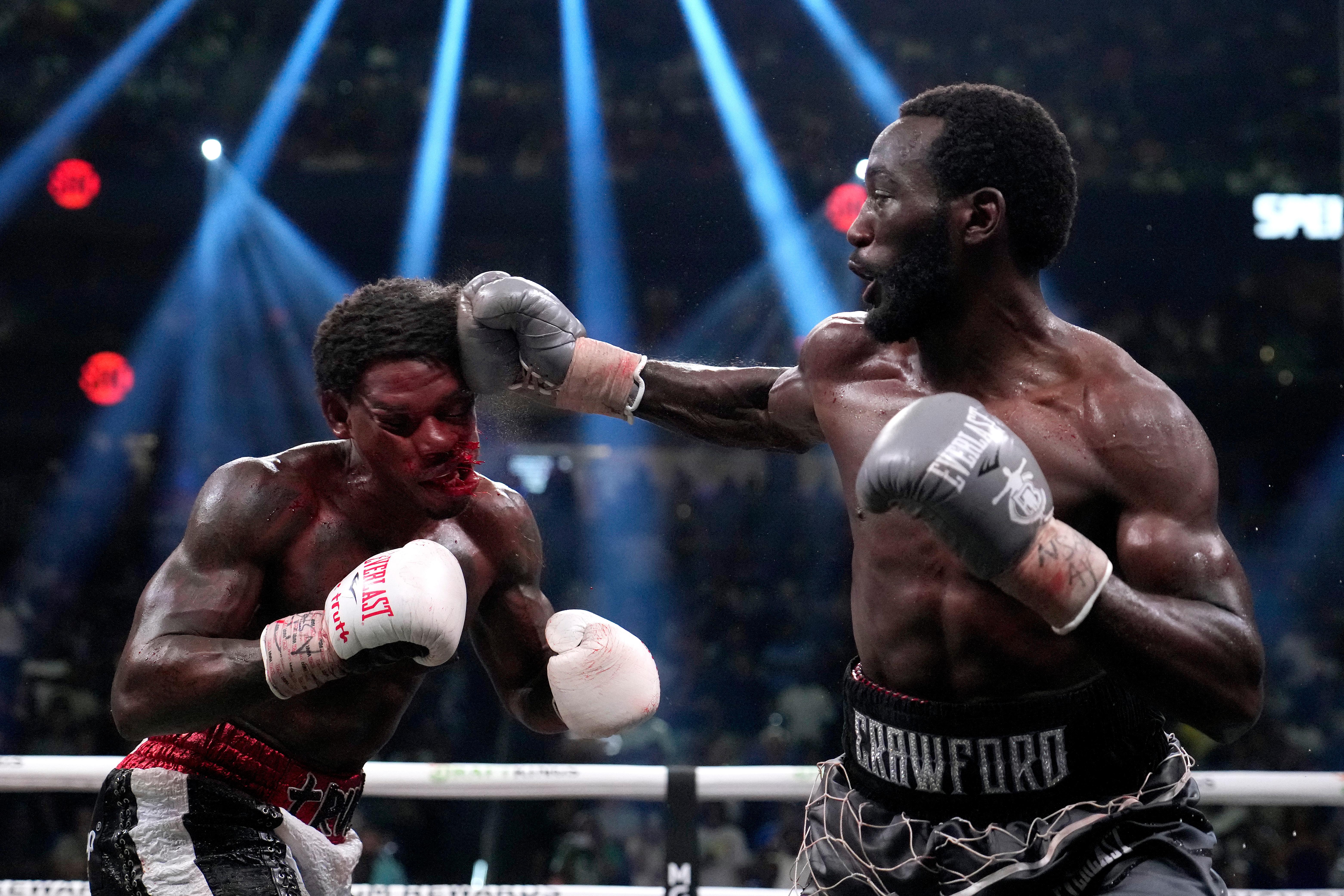 Boxer Errol Spence Jr. is hit by boxer Terence Crawford