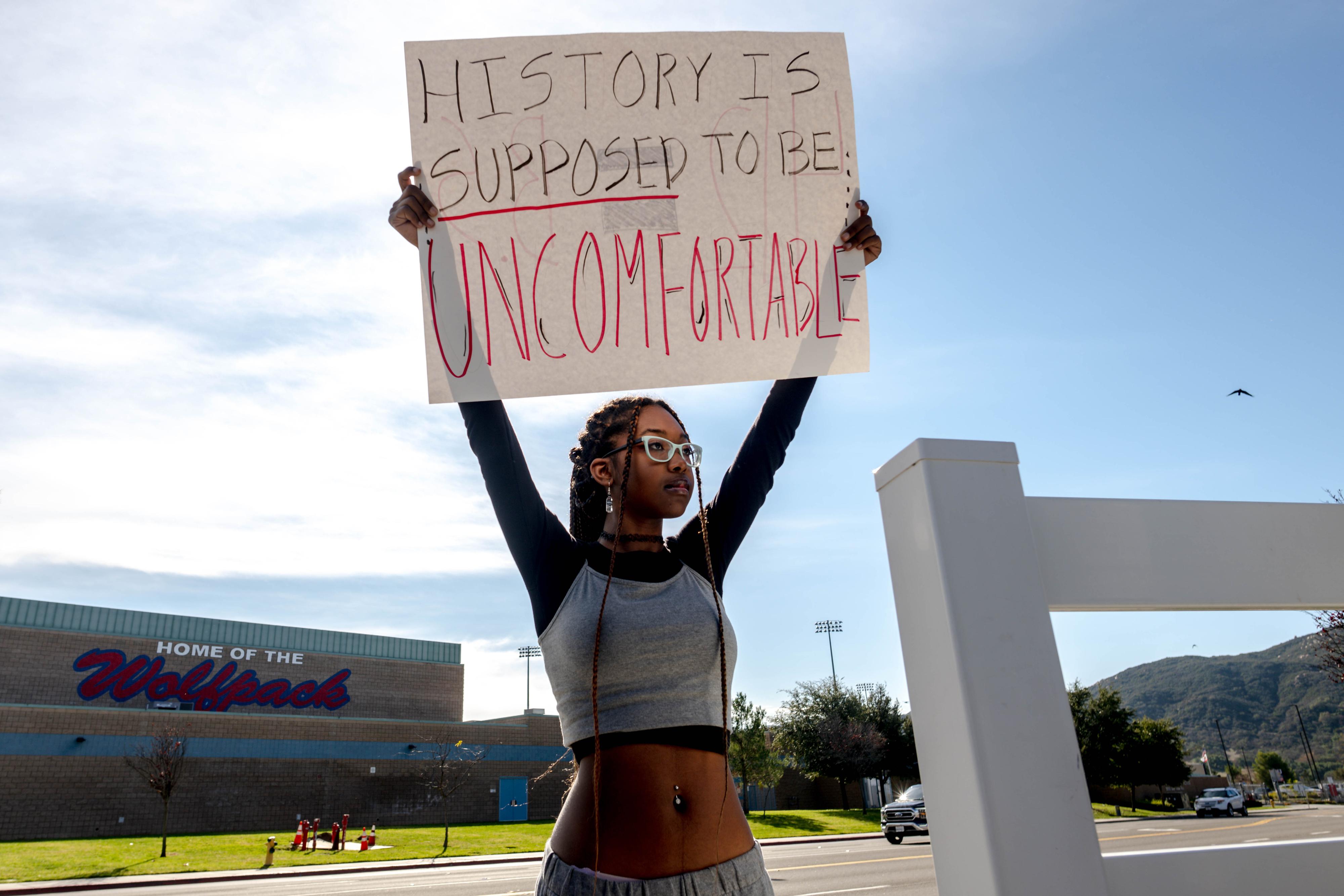 Student Samaya Robinson holds a sign in protest of the districts ban of critical race theory curriculum