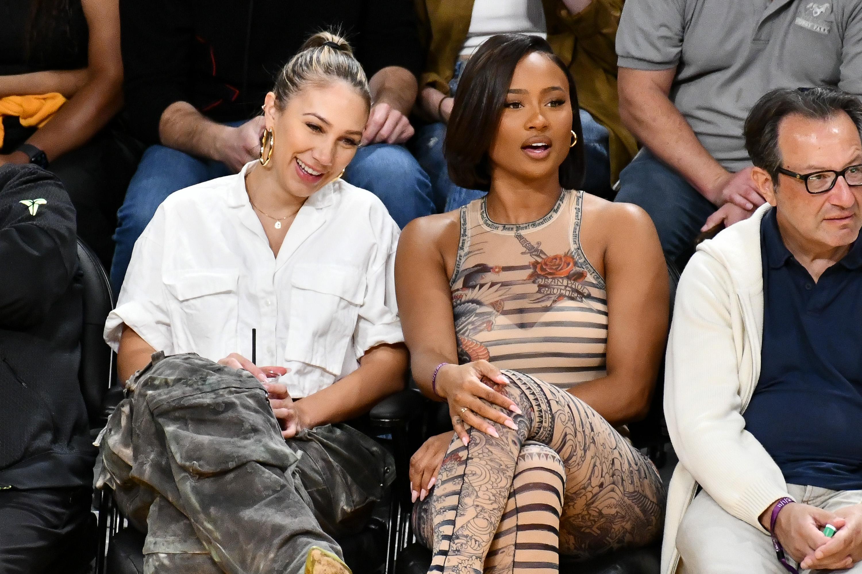 Social media influencer Kayla Nicole (center) attends a basketball game