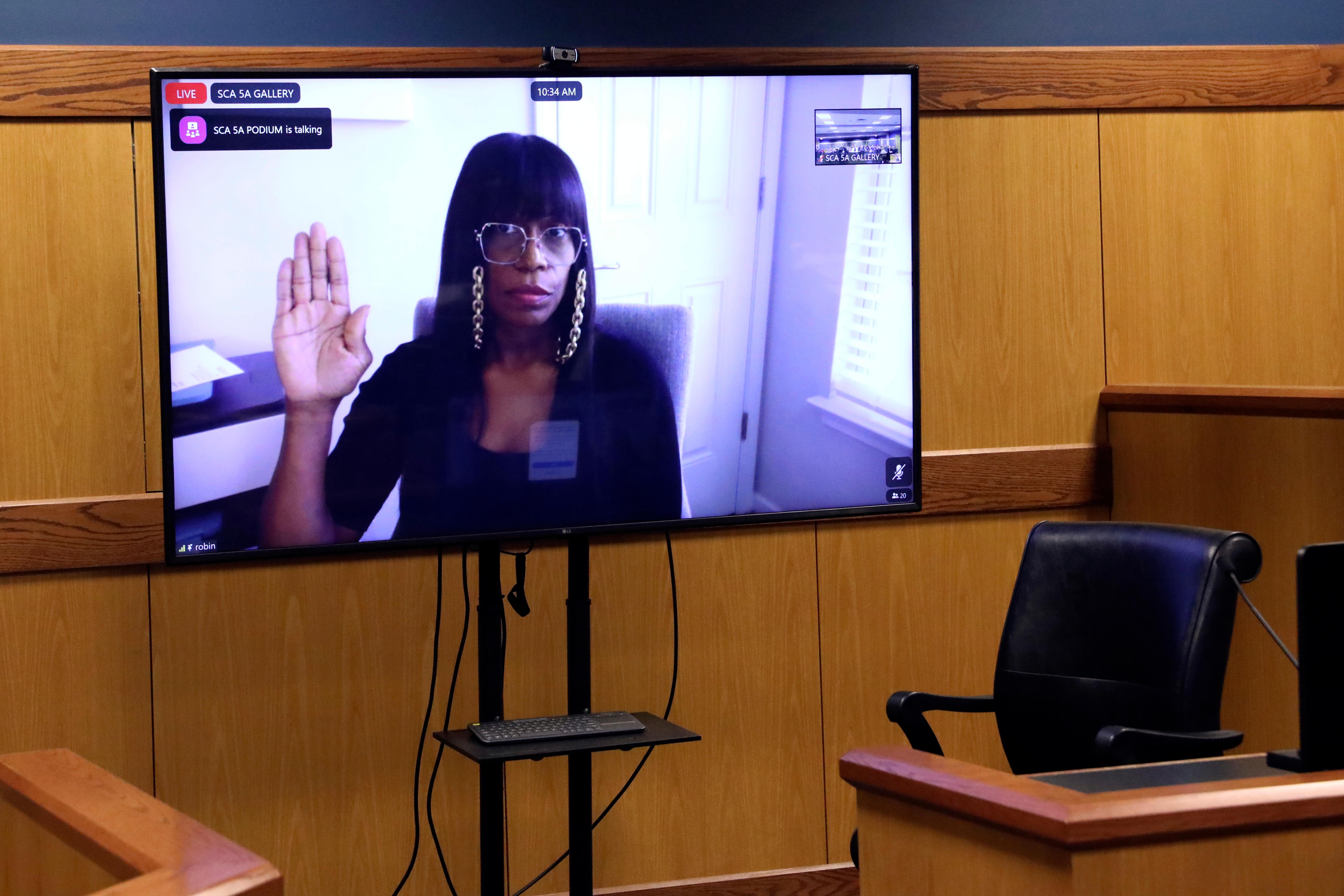 Witness Robin Yeartie is sworn via video during a hearing