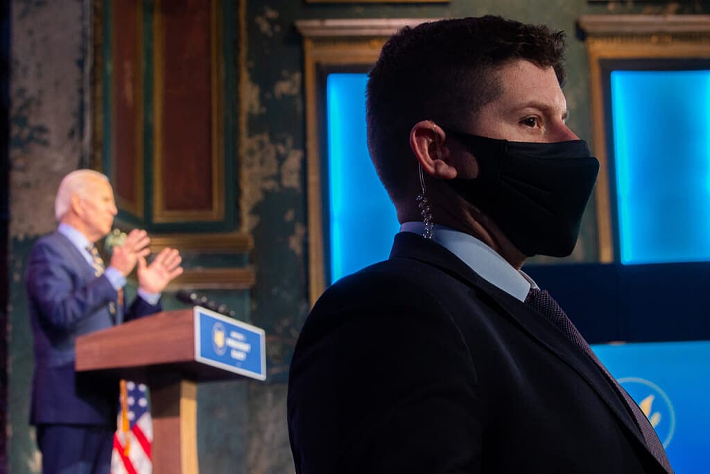 A Secret Service agent with President Joe Biden in the background