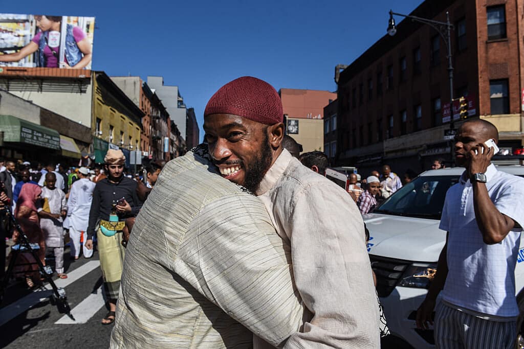 People celebrate at a mosque called the Masjid at-Taqwa after the Eid al-Fitr prayer
