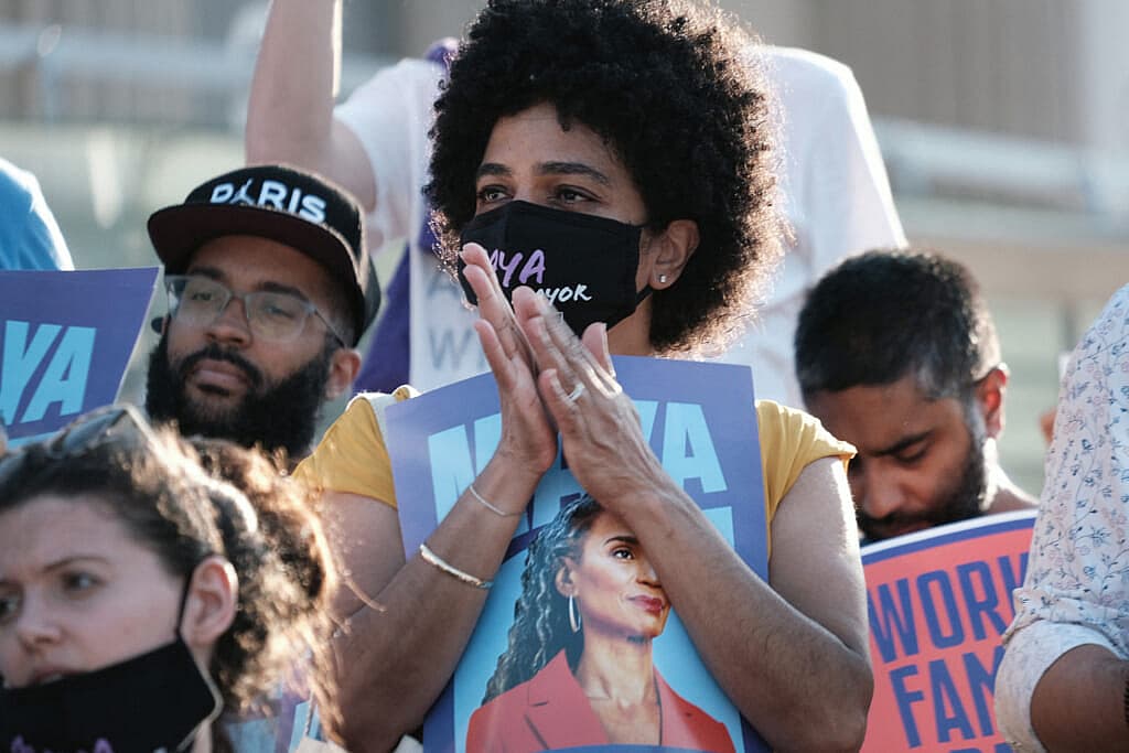 People in a crowd hold posters of New York City mayoral candidate Maya Wiley