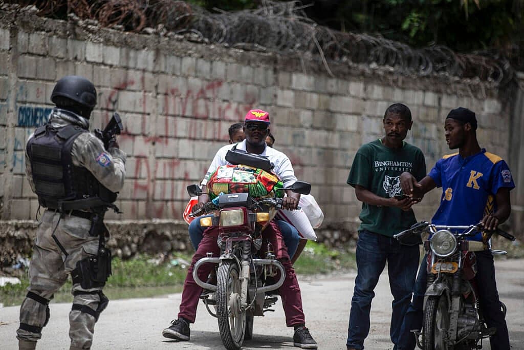 A police officer patrols a street during an anti-gang operation