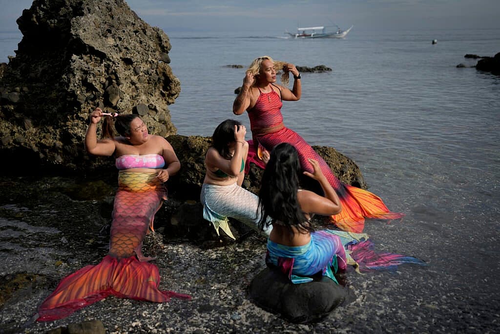 Queen Pangke Tabora, right, and her students prepare for a mermaiding class