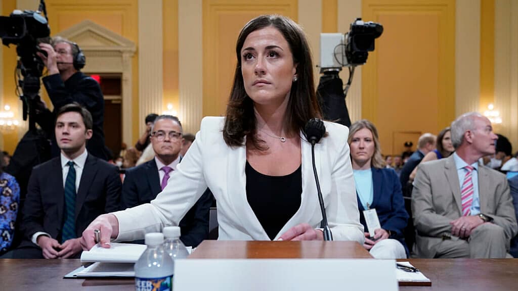 Cassidy Hutchinson, former aide to Trump White House chief of staff Mark Meadows, sitting at a table