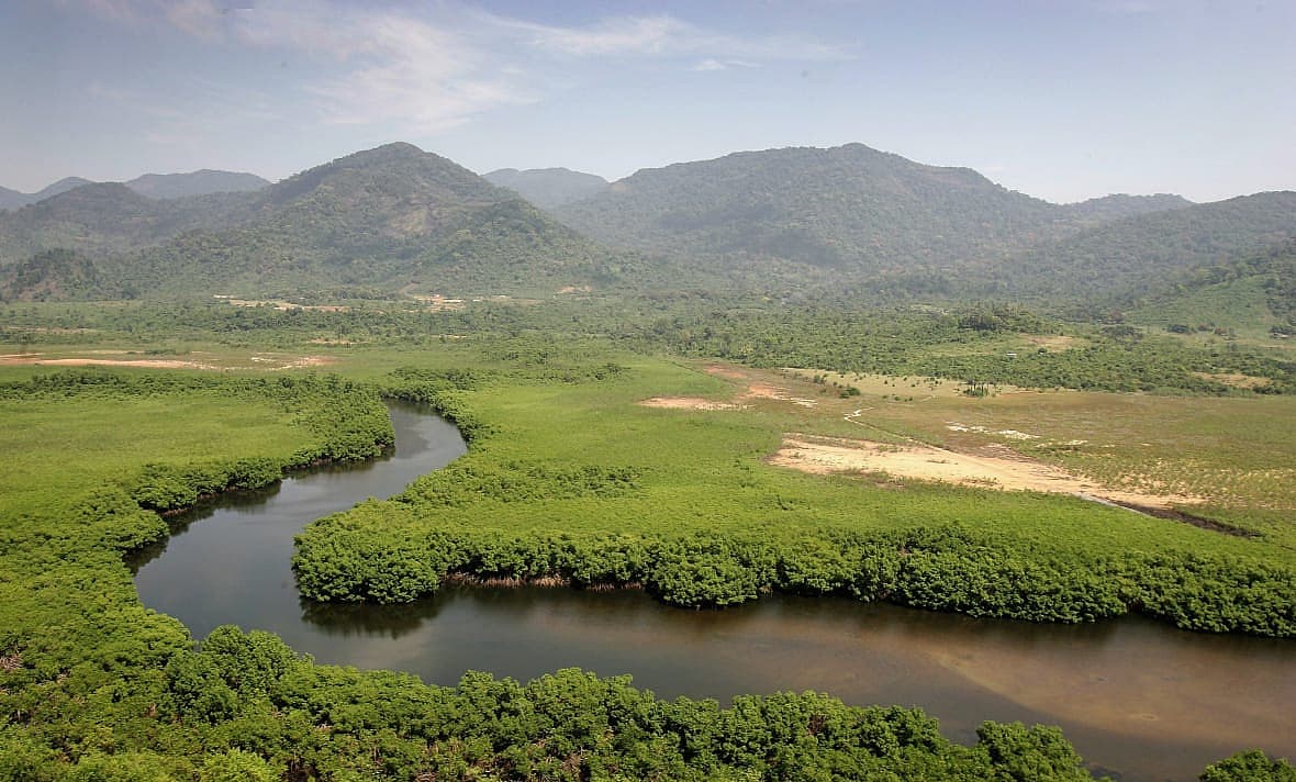 Mountains stand near a river just outside Freetown, Sierra Leone