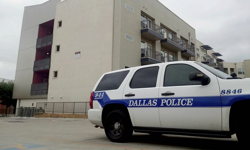 A Dallas Police vehicle parked near the South Side Flats apartments
