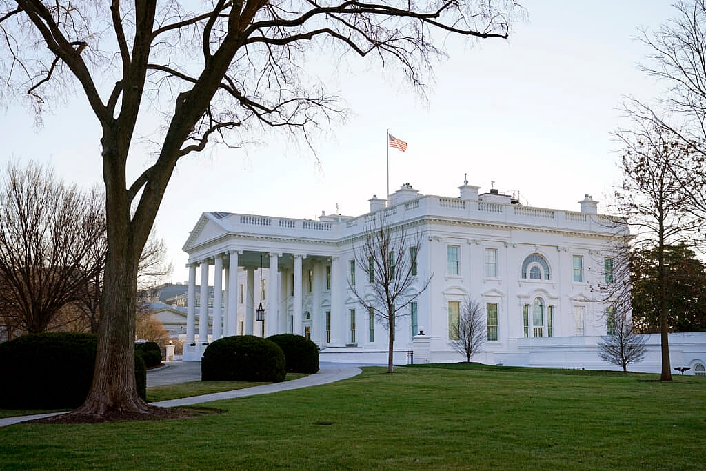 An American flag flies over the White House