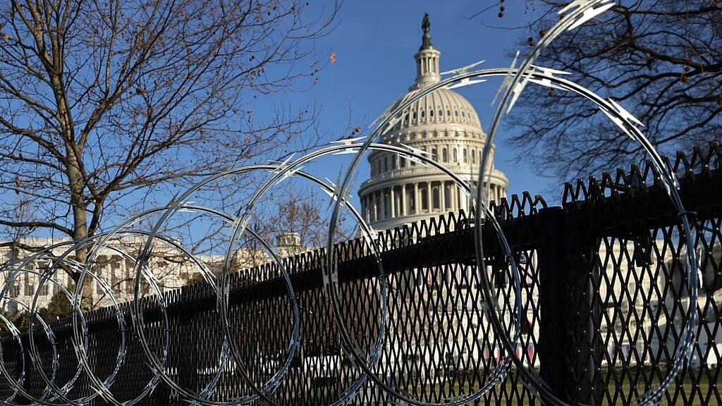 Concertina razor wire is shown along the top of the eight-foot “non-scalable” fence that surrounds the U.S. Capitol