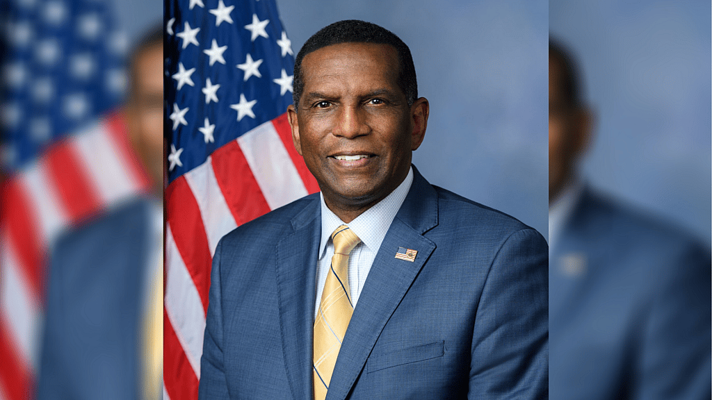 Republican Representative Burgess Owens of Utah wearing a blue jacket and yellow tie