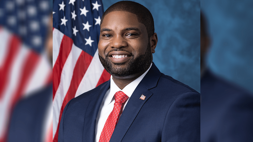 Republican Representative Byron Donalds of Florida wearing a blue jacket and red tie