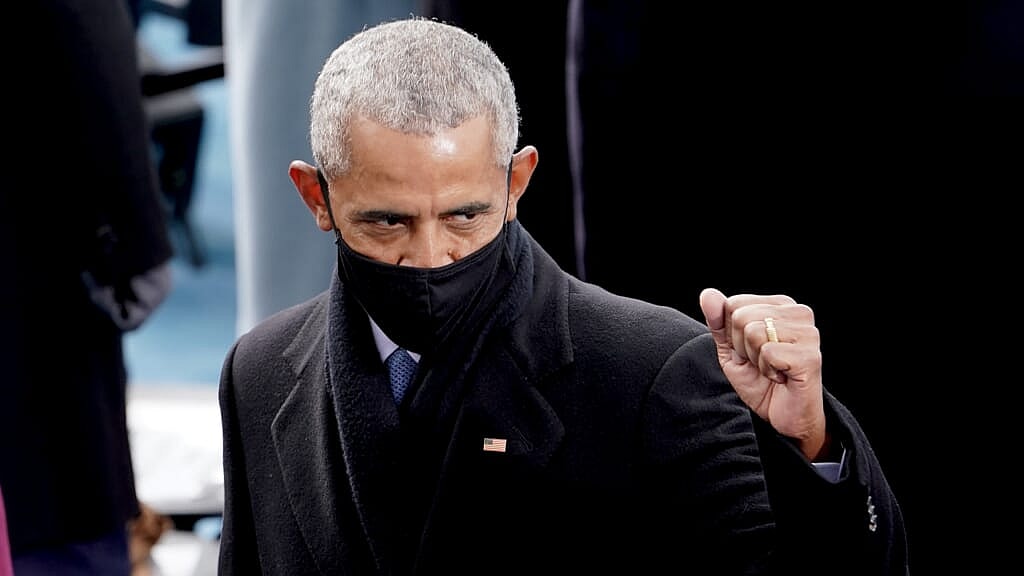 Former President Barack Obama raises a fist