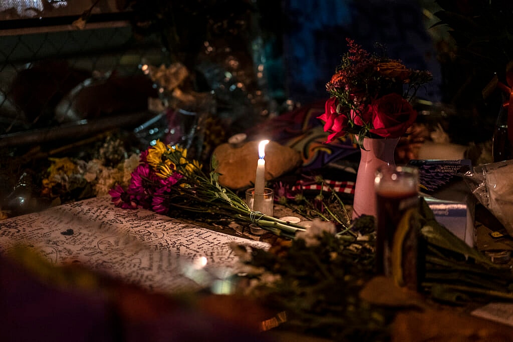 A candle burns at a memorial in Boulder, Colorado
