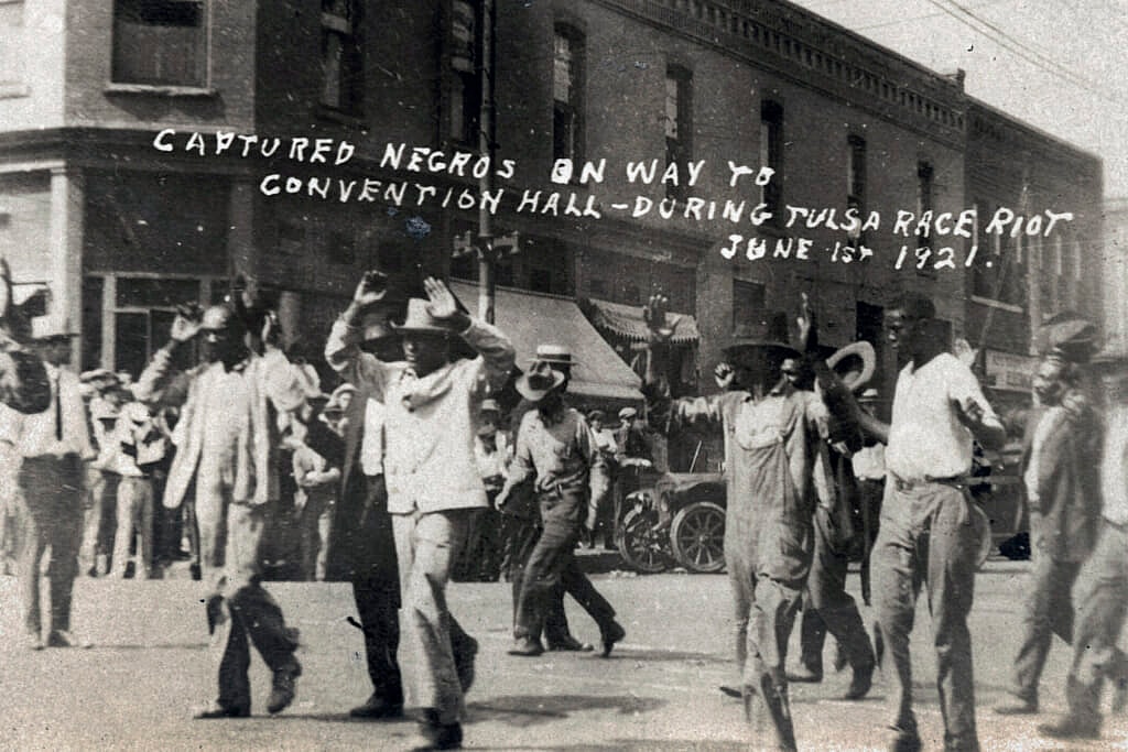 A group of Black men are marched under armed guard during the Tulsa Race Massacre