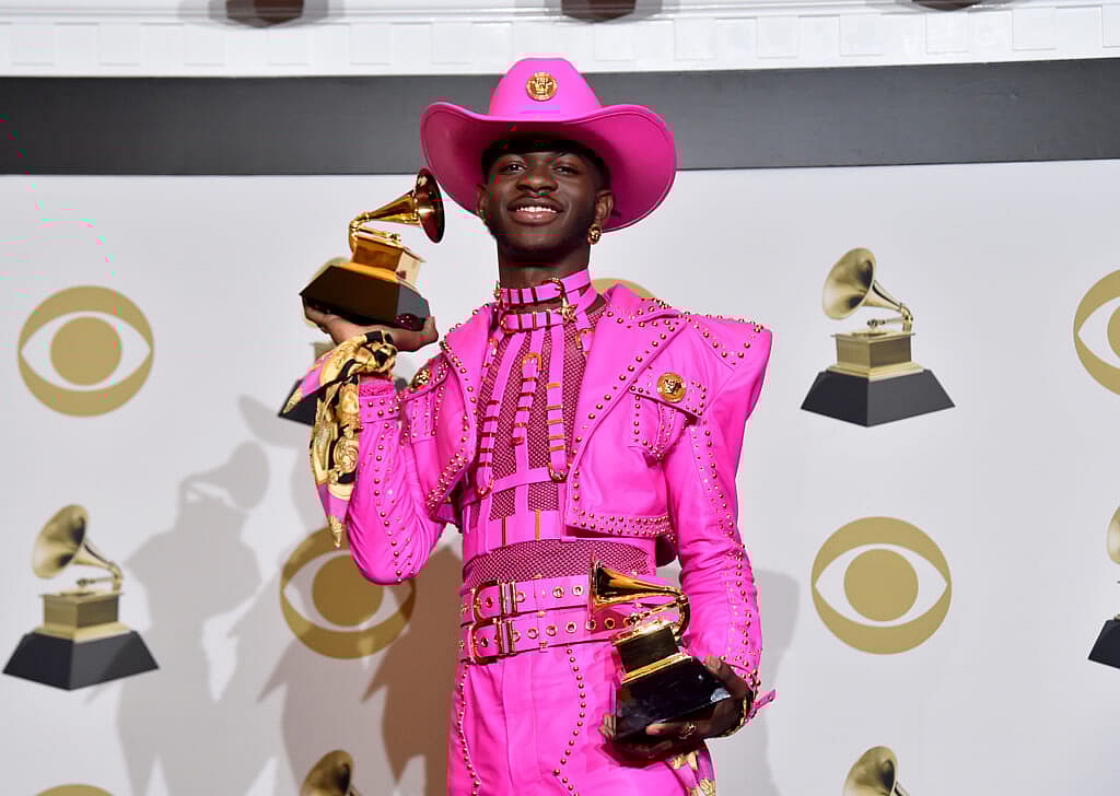 Lil Nas X holding two Grammy awards
