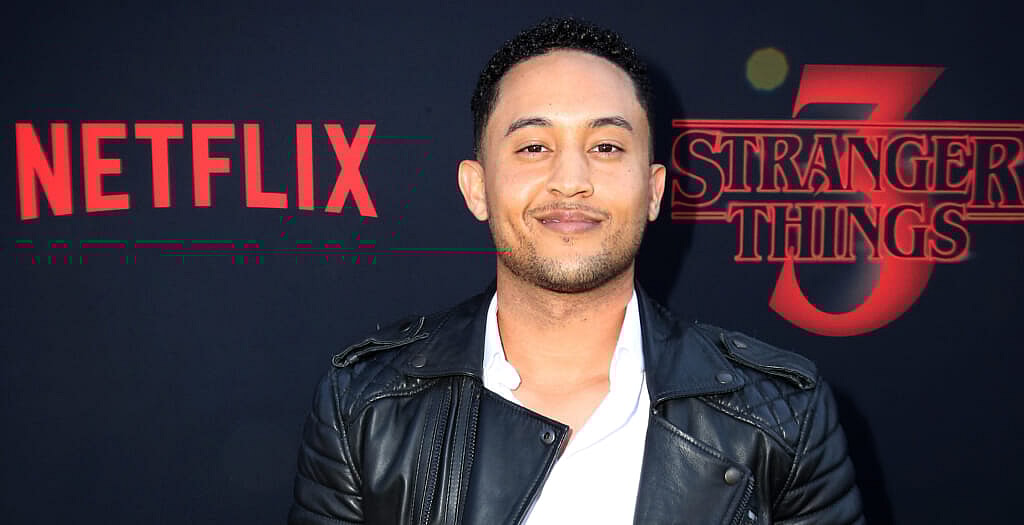 Actor Tahj Mowry wearing a black leather jacket and white shirt