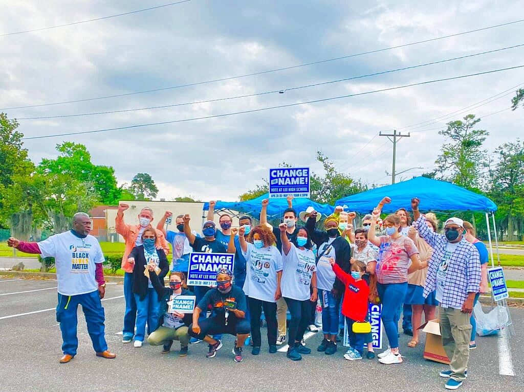 Local activists at a "Stop Playing Games, Change the Names" rally