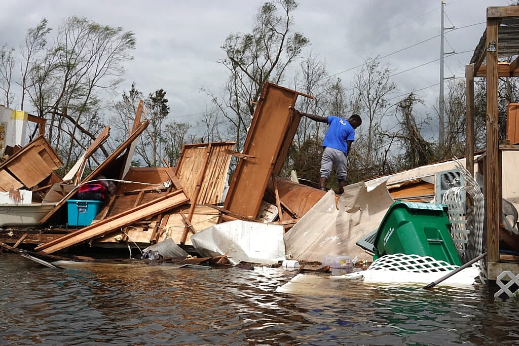 Alonzo Lewis rescues items from his mother’s home after it was destroyed by Hurricane Ida