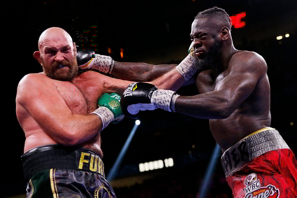 Tyson Fury, of England, and Deontay Wilder trade blows