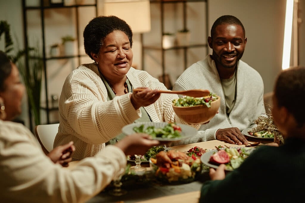 Woman serving people around a table