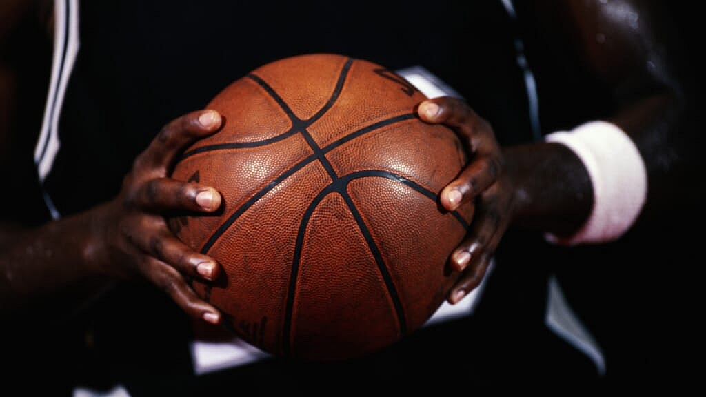 Hands holding a basketball