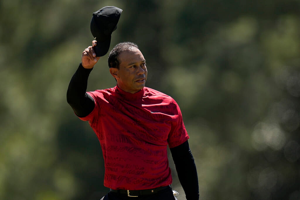 Golfer Tiger Woods tips his cap