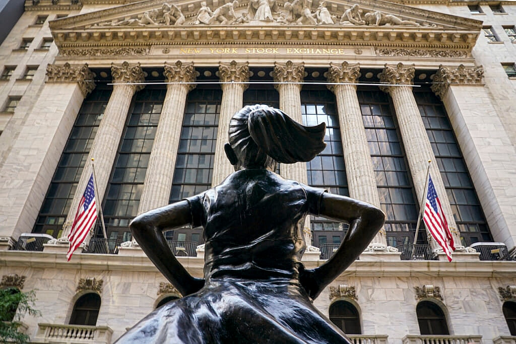 The "Fearless Girl" bronze sculpture looks towards the New York Stock Exchange 