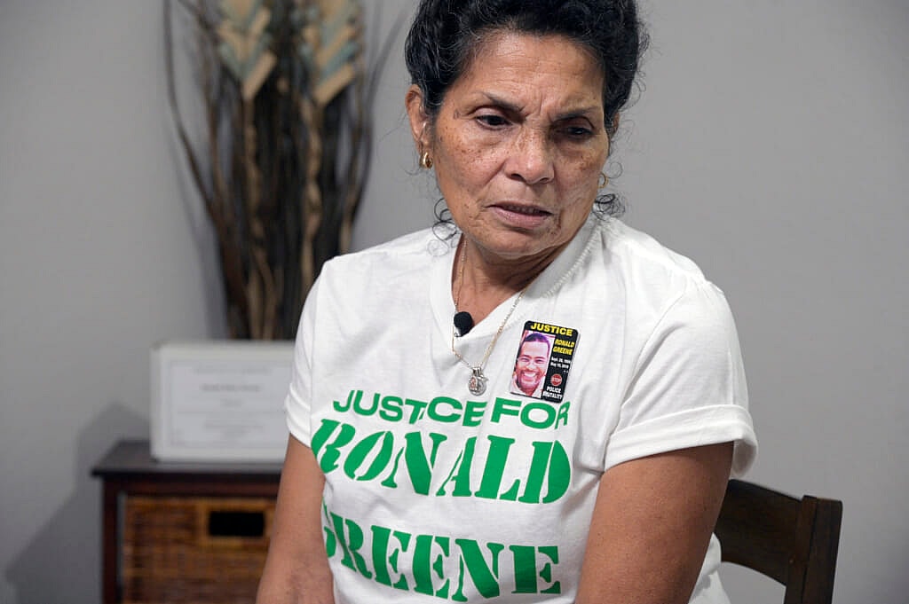 Mona Hardin, mother of Ronald Greene, near his boxed ashes on a table