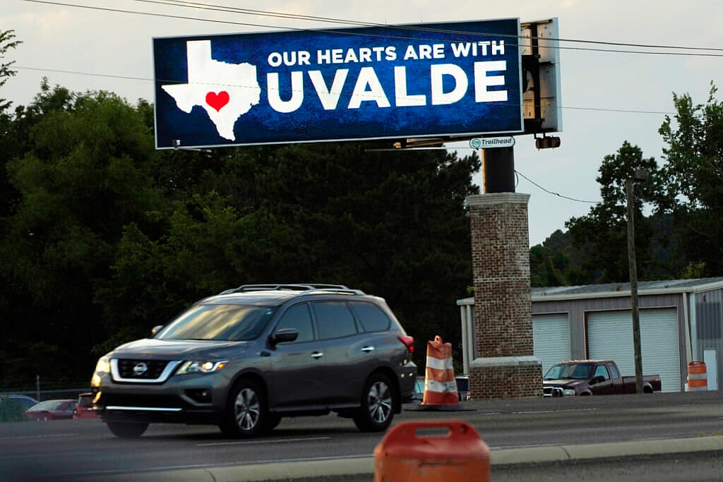 A vehicle passes an electronic billboard reading "Our hearts are with Uvalde"